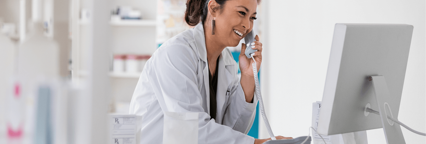 Healthcare professional on phone and computer