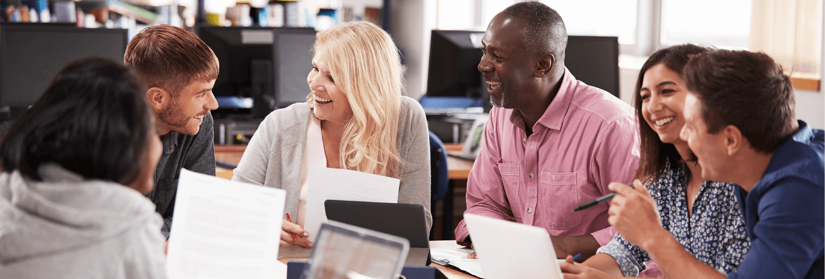 Diverse group reviewing documents at a table